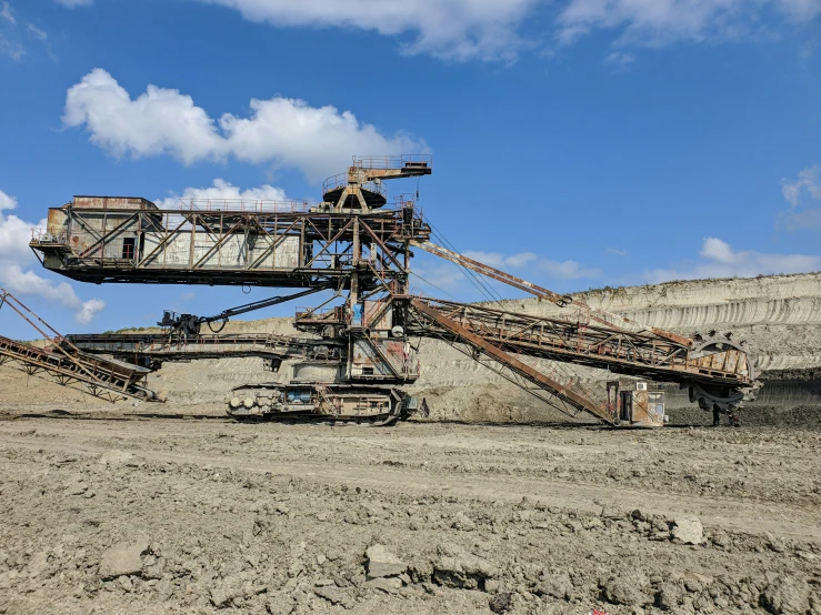 an old mine sitting on the ground with a sky background