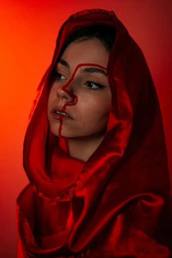 a woman with red make up and a hooded hood