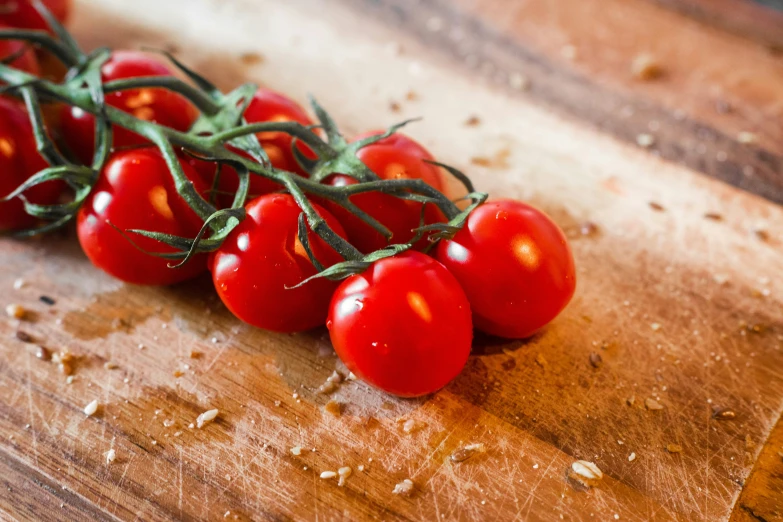 a  board with some red tomatoes on it