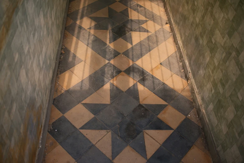 an interesting old, old tiled floor in a restroom