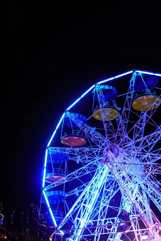 a ferris wheel lit up and illuminated in bright colors