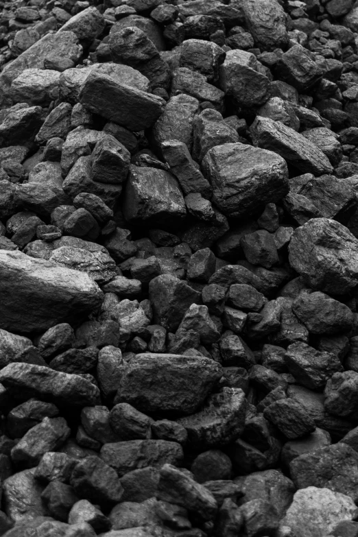 rocks on top of a hill side with sky in the background