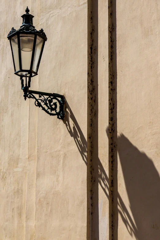 lamppost casting shadow with large shadow behind it