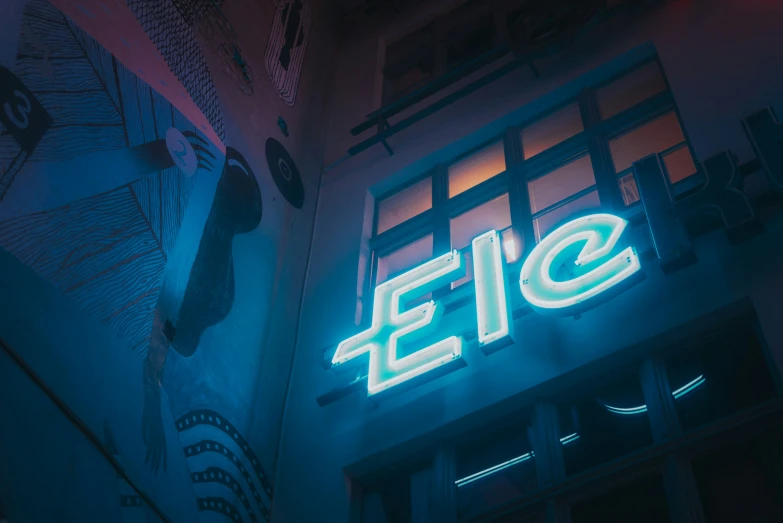 the neon sign says eie for a building in a city