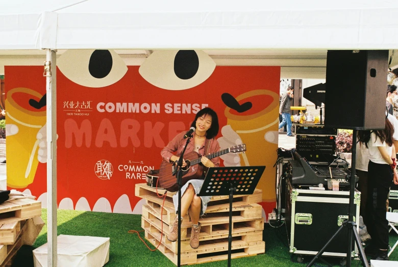 a woman that is standing up with a guitar