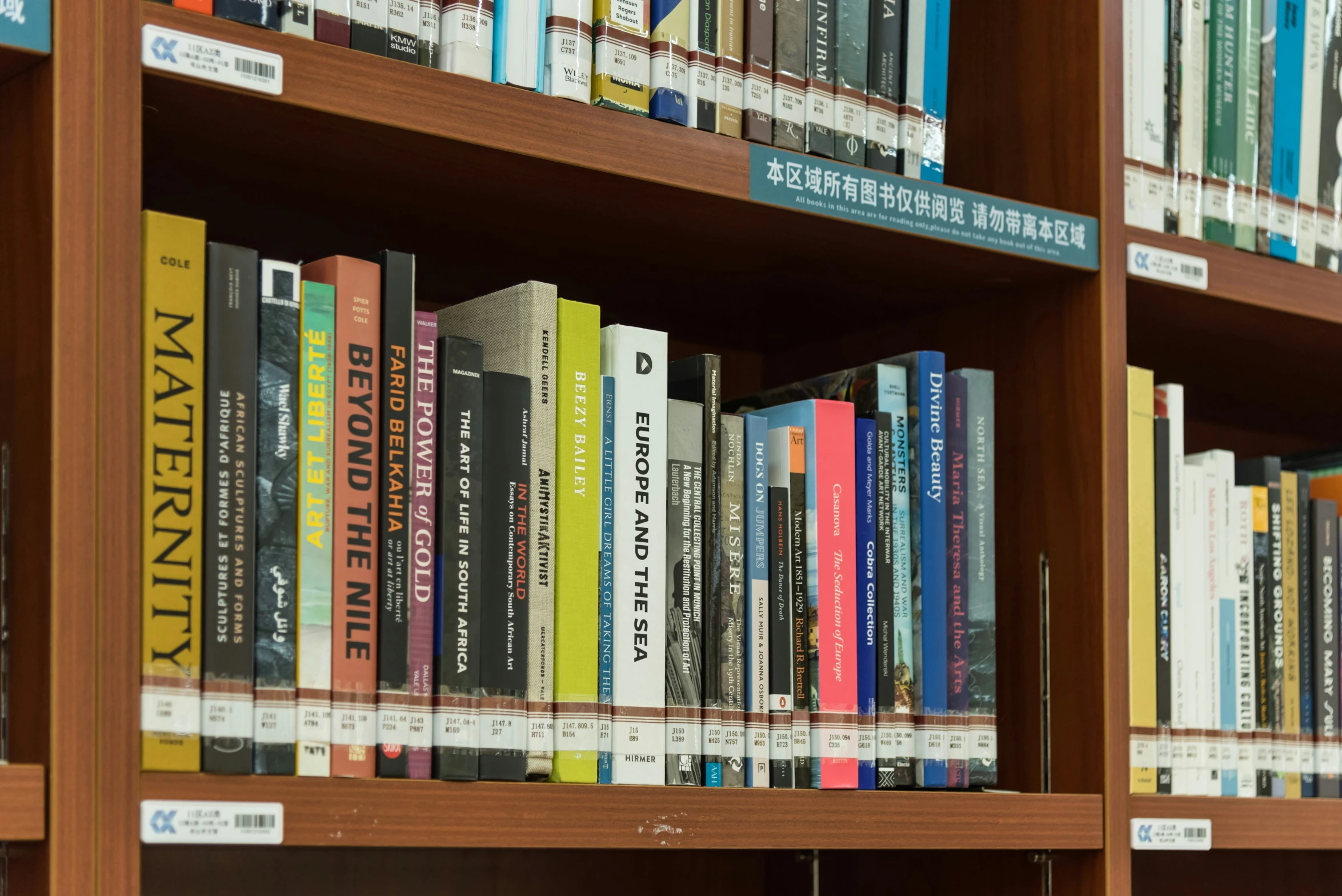 an assortment of books on a shelf in the liry