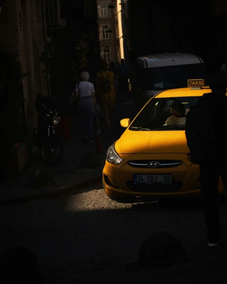 a taxis cab is stopped with its hood up