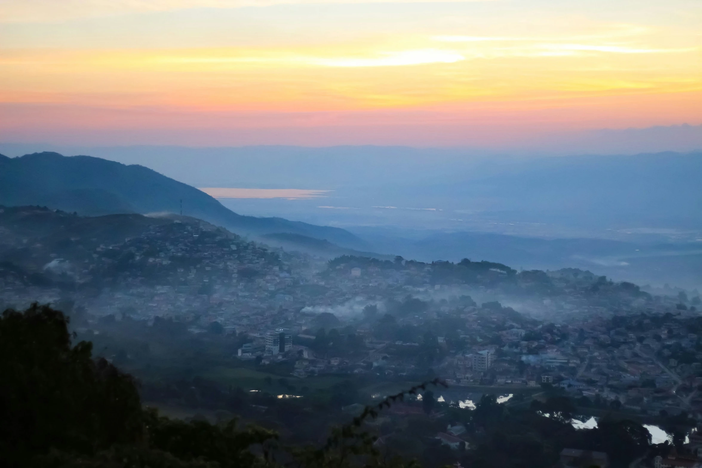 the mountains with a small town at sunset