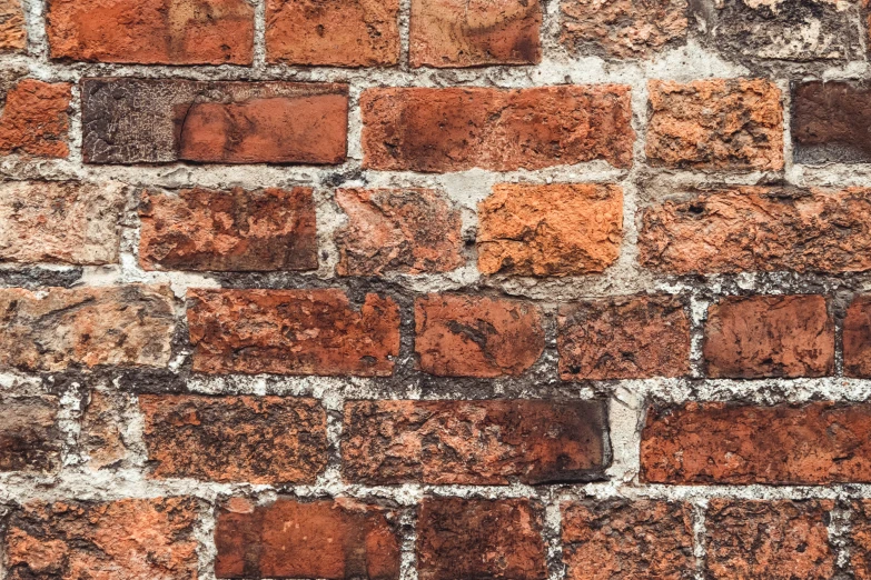 a closeup of red bricks with one side exposed