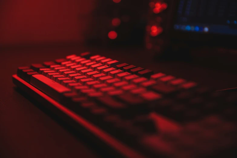 a bright red computer keyboard on a black surface