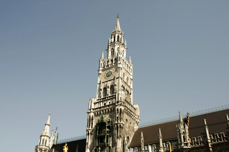 an old brick building with tall spires and a clock