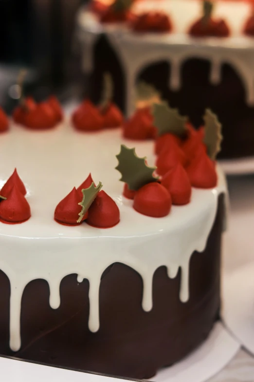 some cake with white icing and strawberries on top