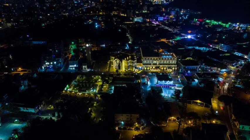 a city view at night with colorful lights and buildings