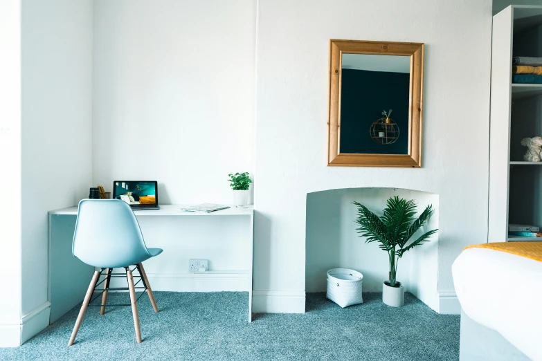 a small living room with chairs, an empty dresser and mirror