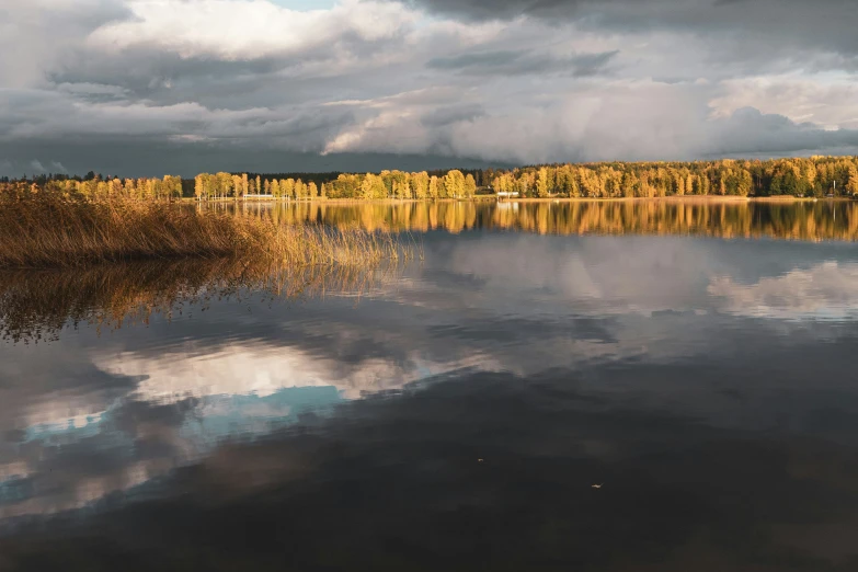 a very calm and peaceful lake with mountains in the background