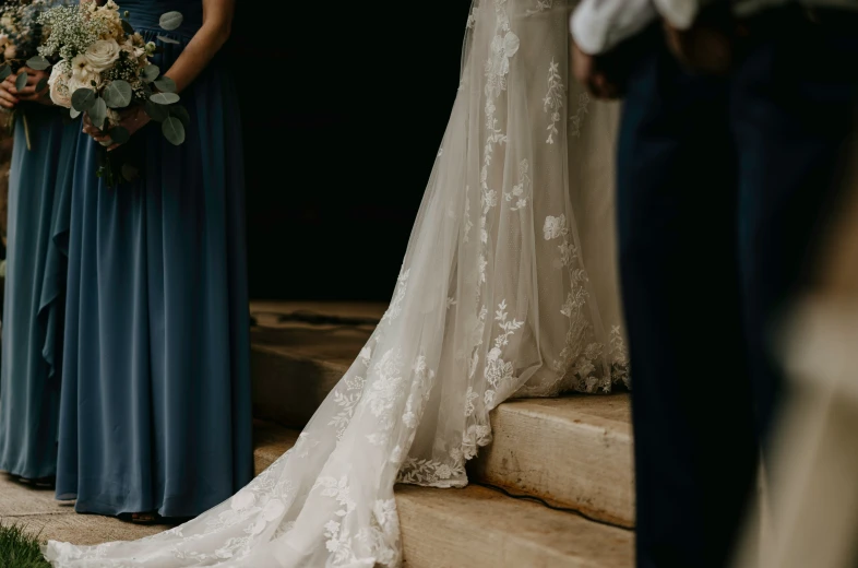 the bride and her bridesmaids standing on steps