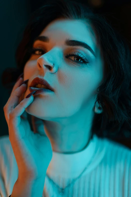 a woman wearing a white sweater smoking a cigarette