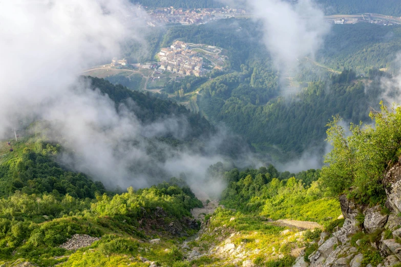 a scenic view of a valley with low clouds