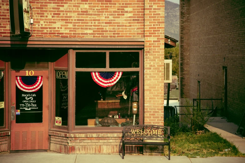 an old brick building with some american flags on it