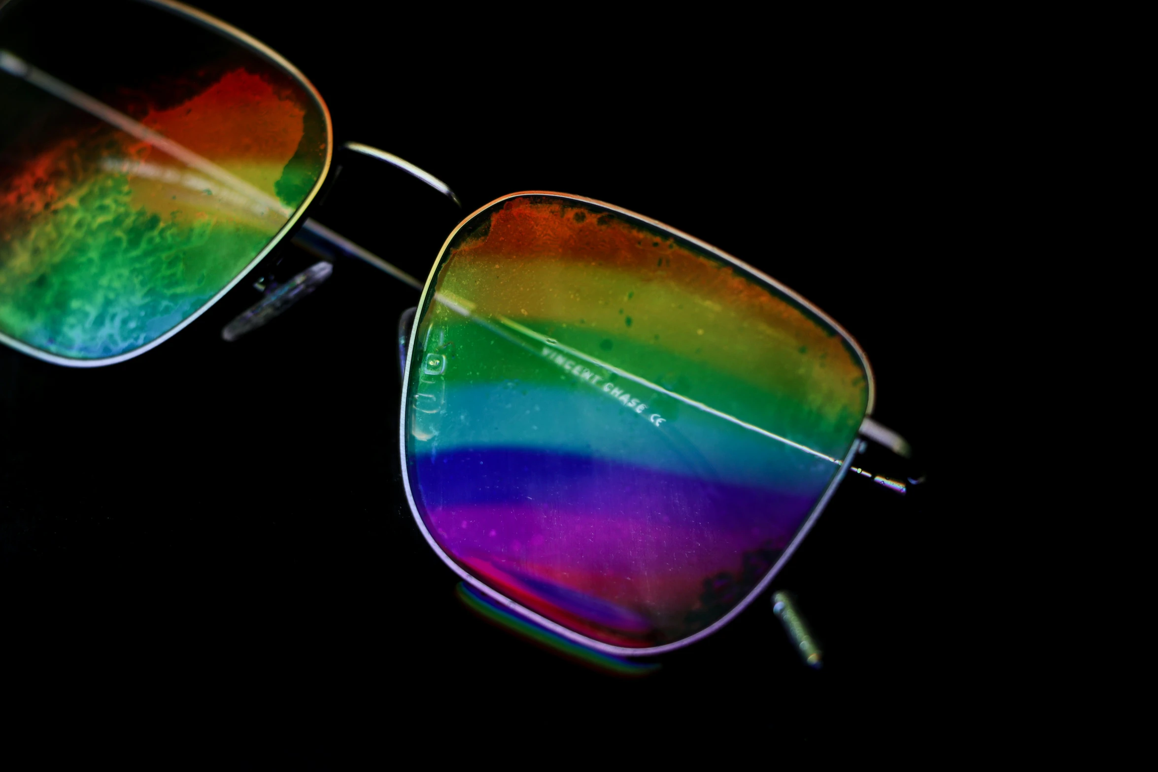 an image of some rainbow glasses on a black background