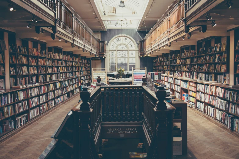 the bookshelves inside a liry with a view of the ceiling