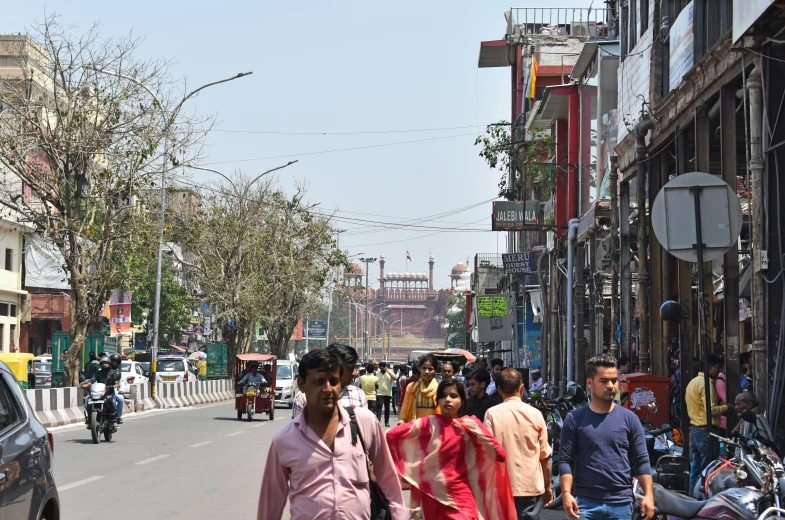 people walk down the street in a small city