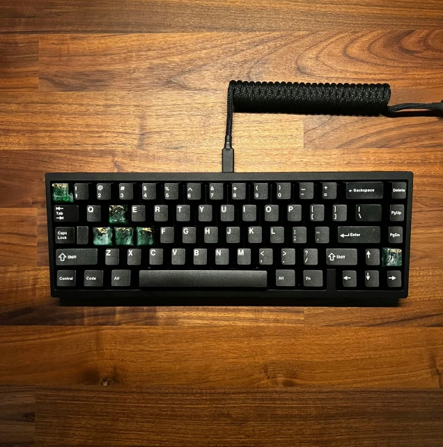 an apple keyboard sits on the floor, with a mouse and pad