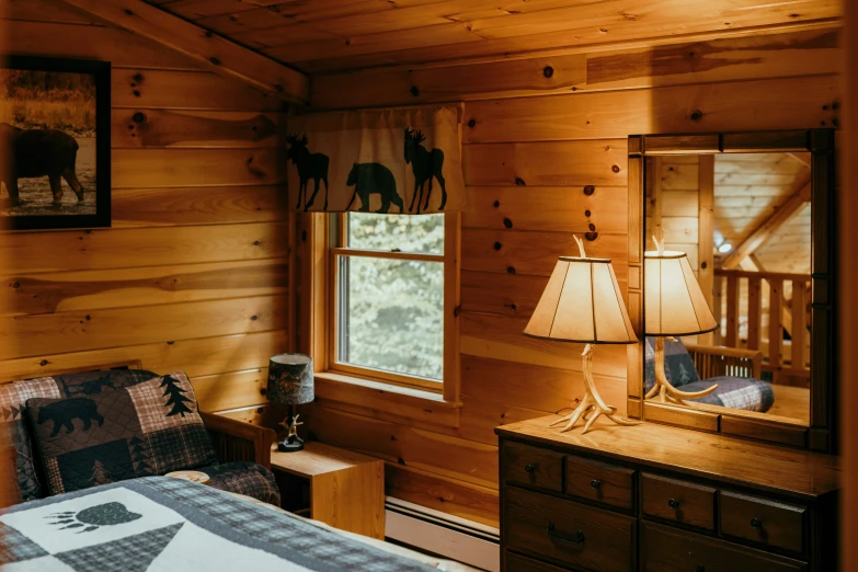 the bedroom has a wooden wall and has an animal theme