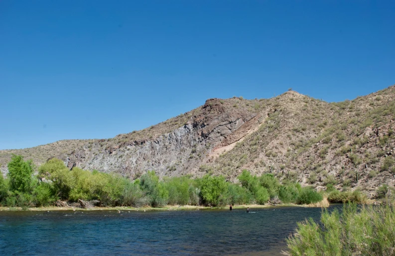 a beautiful view of a body of water next to some hills