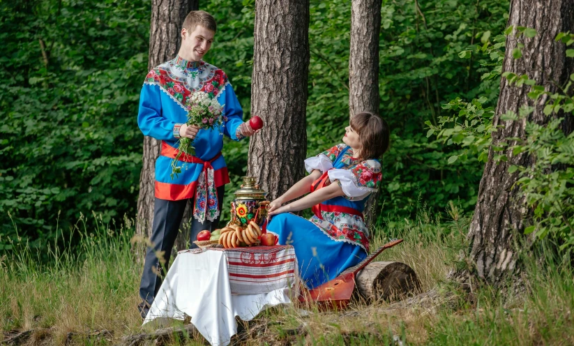 a  and a girl standing in the forest