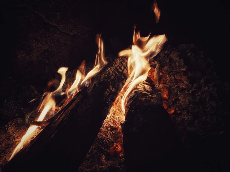 flames of wood burning in a cave at night