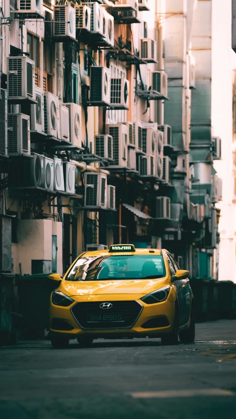 a yellow car parked in front of a bunch of buildings