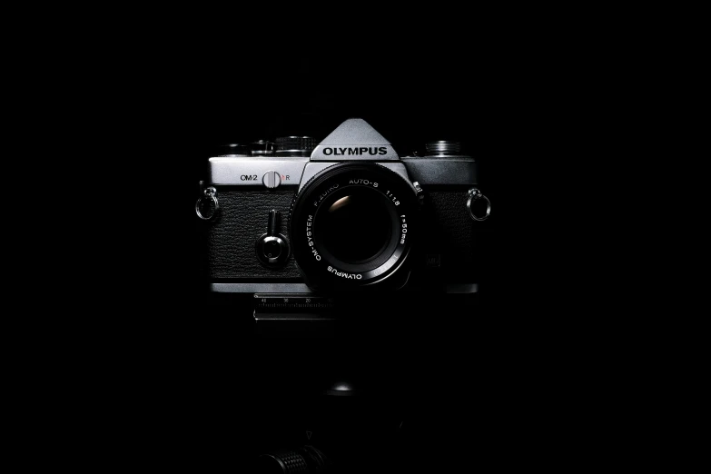 a camera is sitting against a dark backdrop