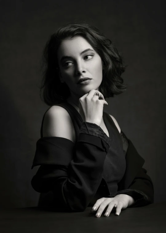 a beautiful woman leaning on a wooden table