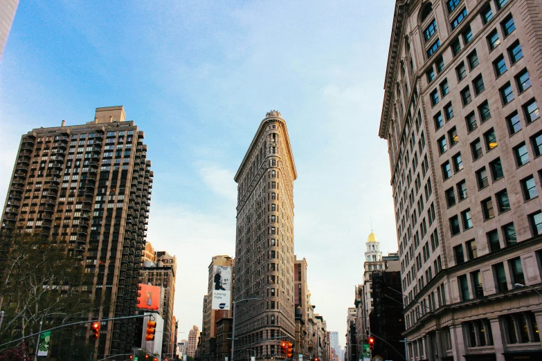 two large buildings are shown against a bright blue sky