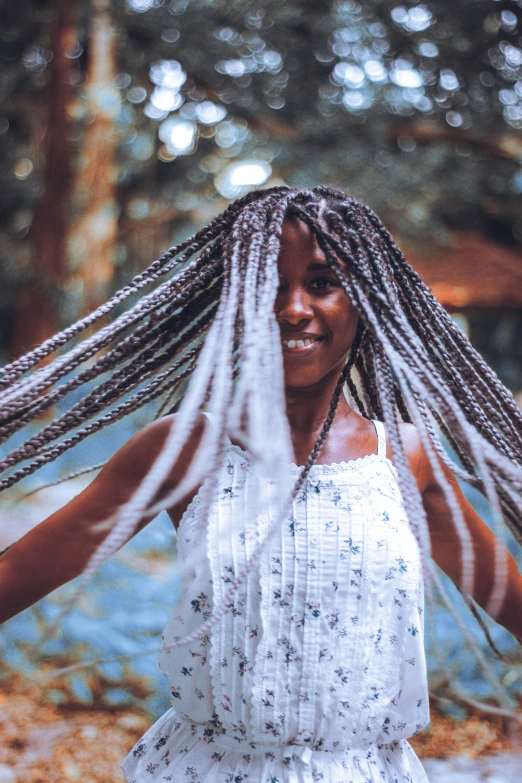 a woman with her hair pulled back with long white dreadlocks