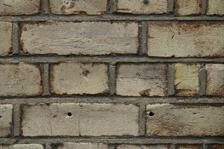 a close up of brick textured with dirt