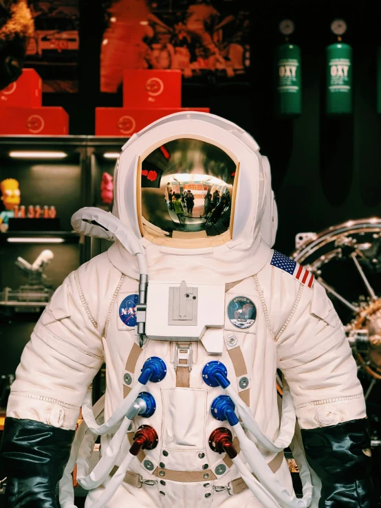 an astronaut standing in a museum display in his space suit