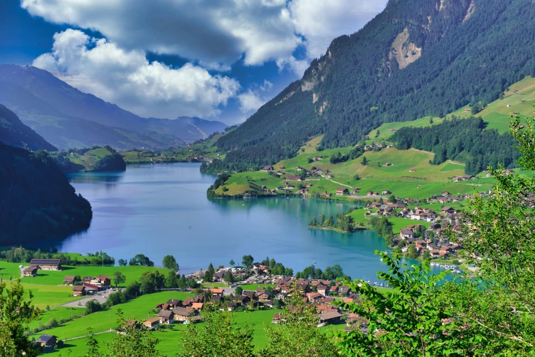 a lake surrounded by lush green hills and mountains