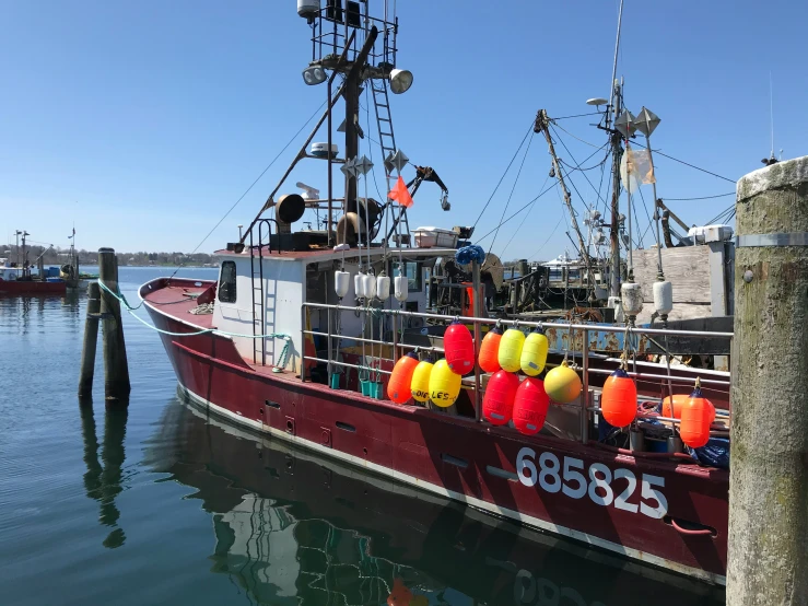 the front of the boat has brightly colored buoys