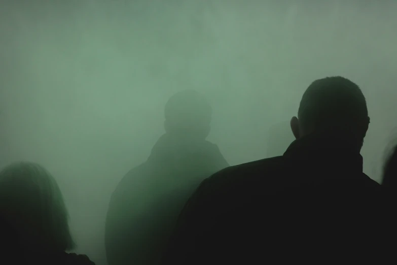 a group of people standing in the fog