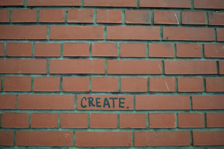 brick wall with sign, words created in chalk