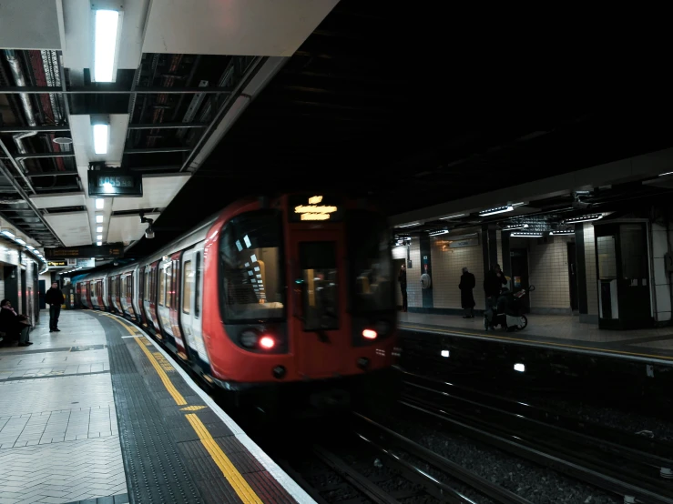 a commuter train is pulled in to a station platform