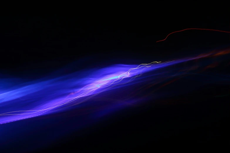 an abstract picture of blue lights, in the dark