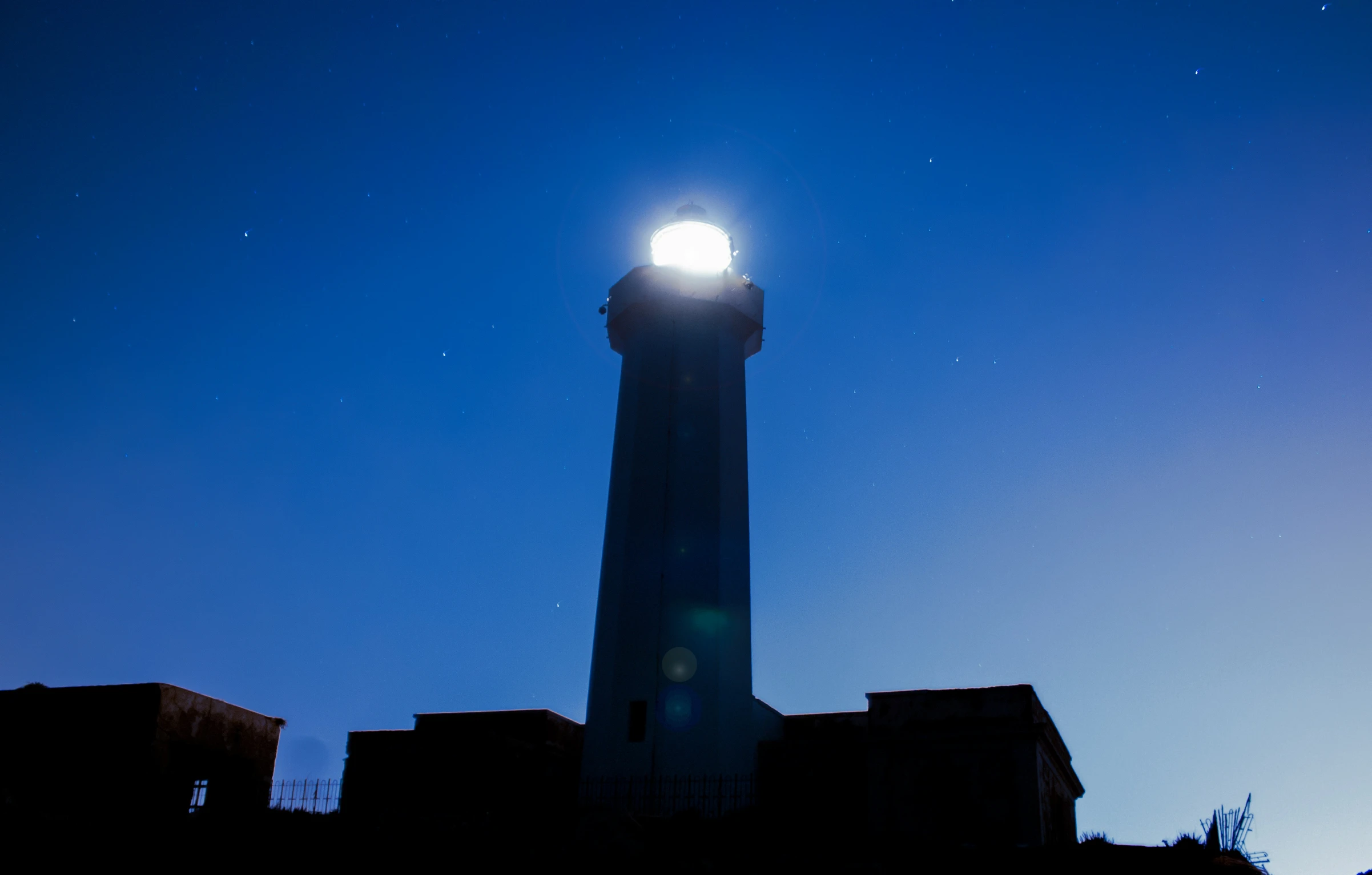 the silhouette of a clock tower is shown against a night sky