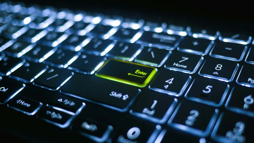 a keyboard with a yellow key placed on it