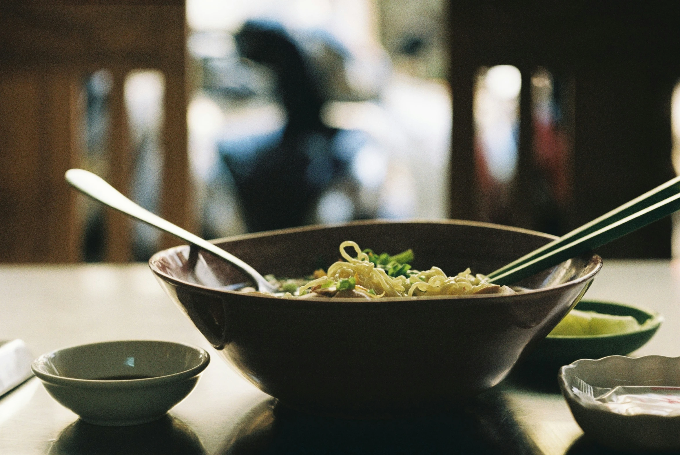 a bowl filled with a salad next to two spoons