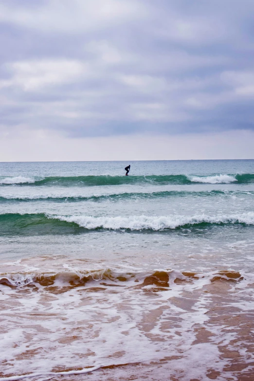 the surfer is in the ocean riding the wave