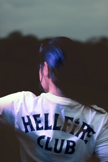 a woman is wearing a white shirt that says hellaf club