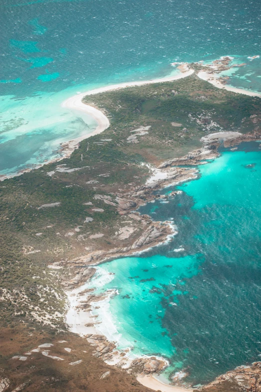 an airplane wing that is flying over a body of water